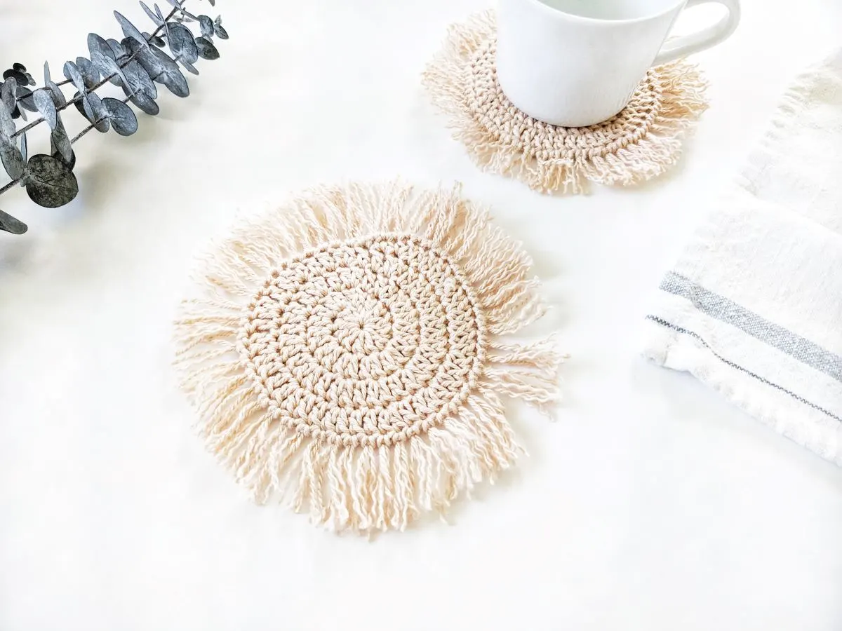 cotton boho crochet coaster with fringe and white tea cup and tea towel