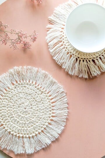 A crochet circle coaster and a crochet spiral coaster.