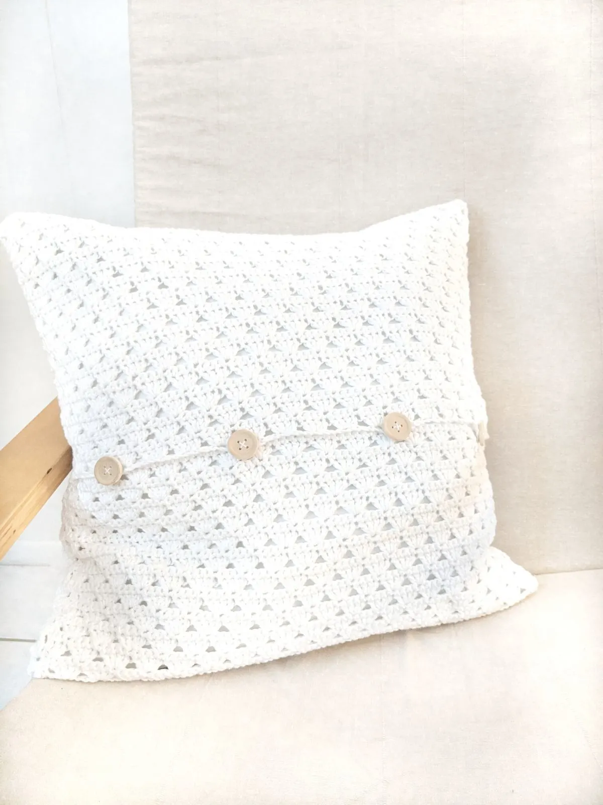 a free textured crochet pillow cover pattern on an Ikea chair.
