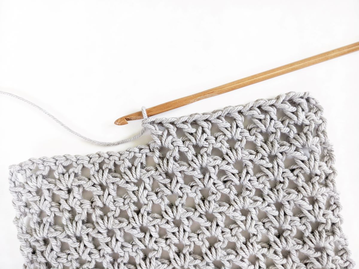 double crochet v-stitch swatch made with cotton yarn and a wooden crochet hook