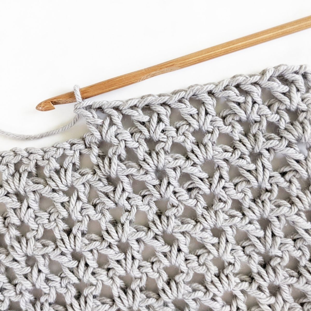 double crochet v-stitch swatch made with cotton yarn and a wooden crochet hook