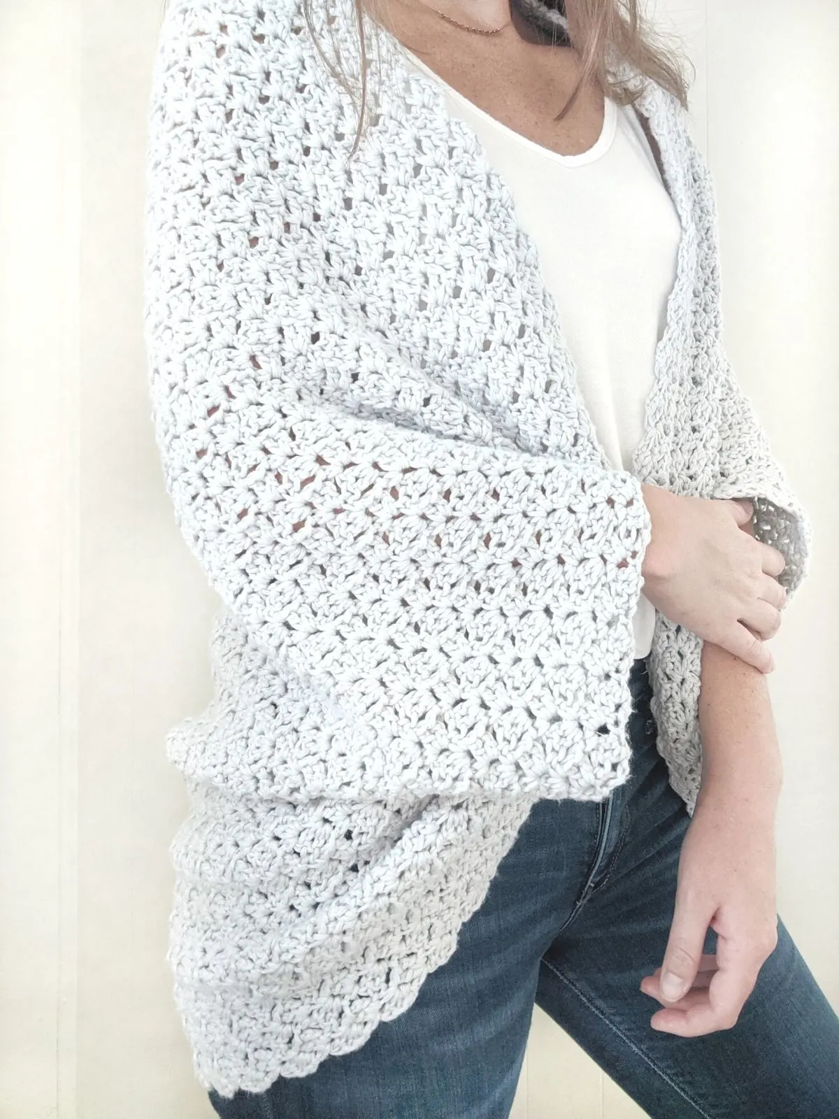 model wearing a crochet shrug that is made with Loops and Thread Crème cotton yarn.