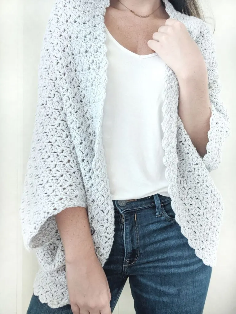 cotton crochet blanket shrug worn with a pair of jeans and white top