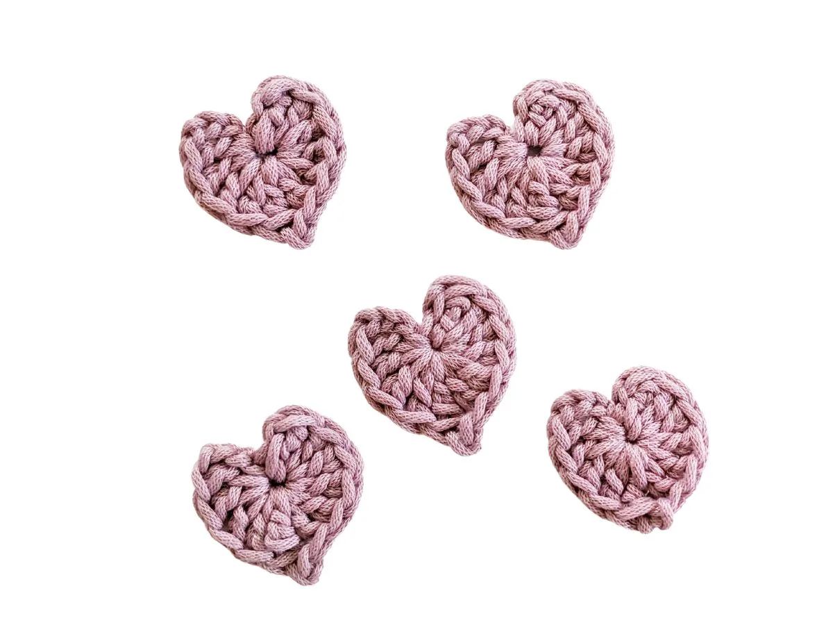 Mini crochet hearts made with worsted weight yarn.
