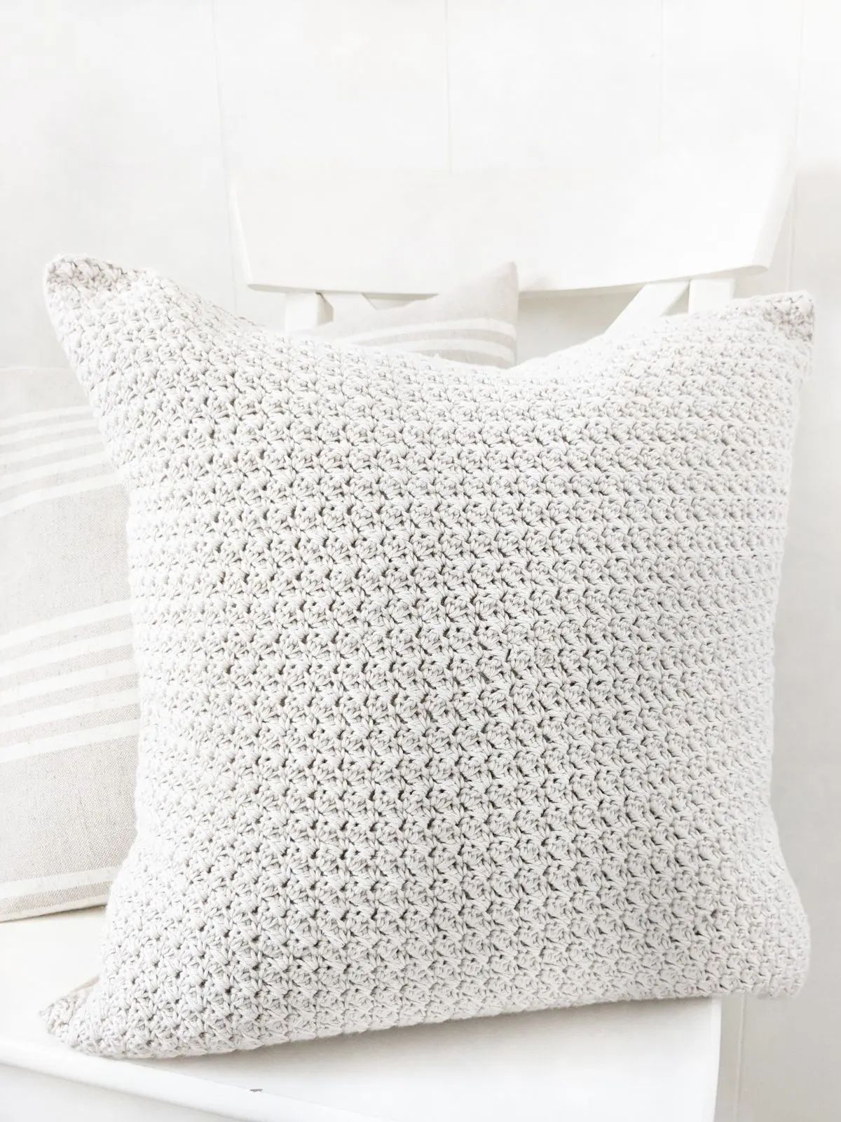 A crochet pillow made using the suzette stitch.