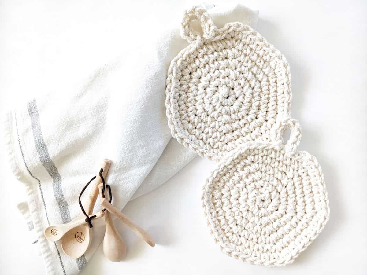 easy crochet hot pads for your kitchen. Crochet hot pad pictured with a dishcloth and wooden spoons