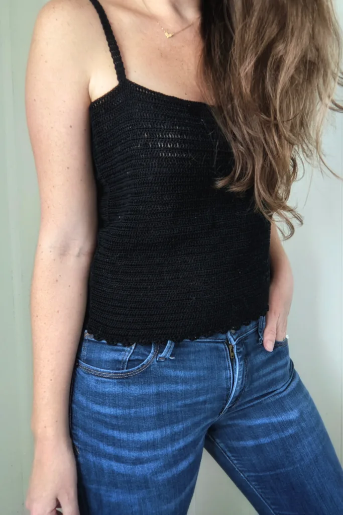 Side view of the crochet lace tank top in the color black