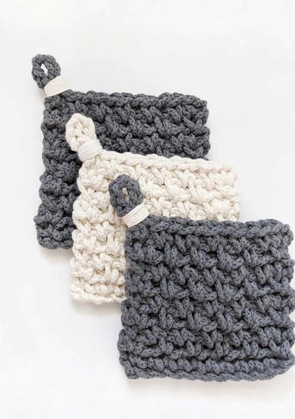 3 modern chunky crochet coasters made with cotton yarn in the color white and blue