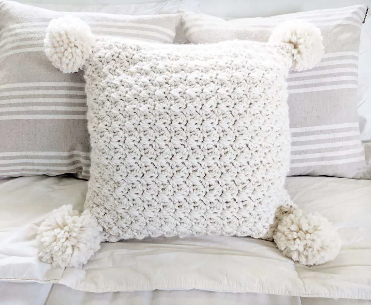 full view of the crochet chunky pillow on a bed
