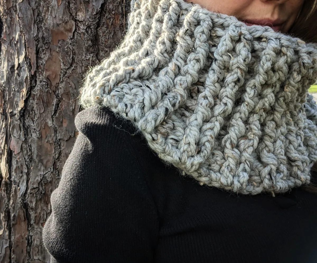 model is wearing a bulky weight crochet cowl in the color grey