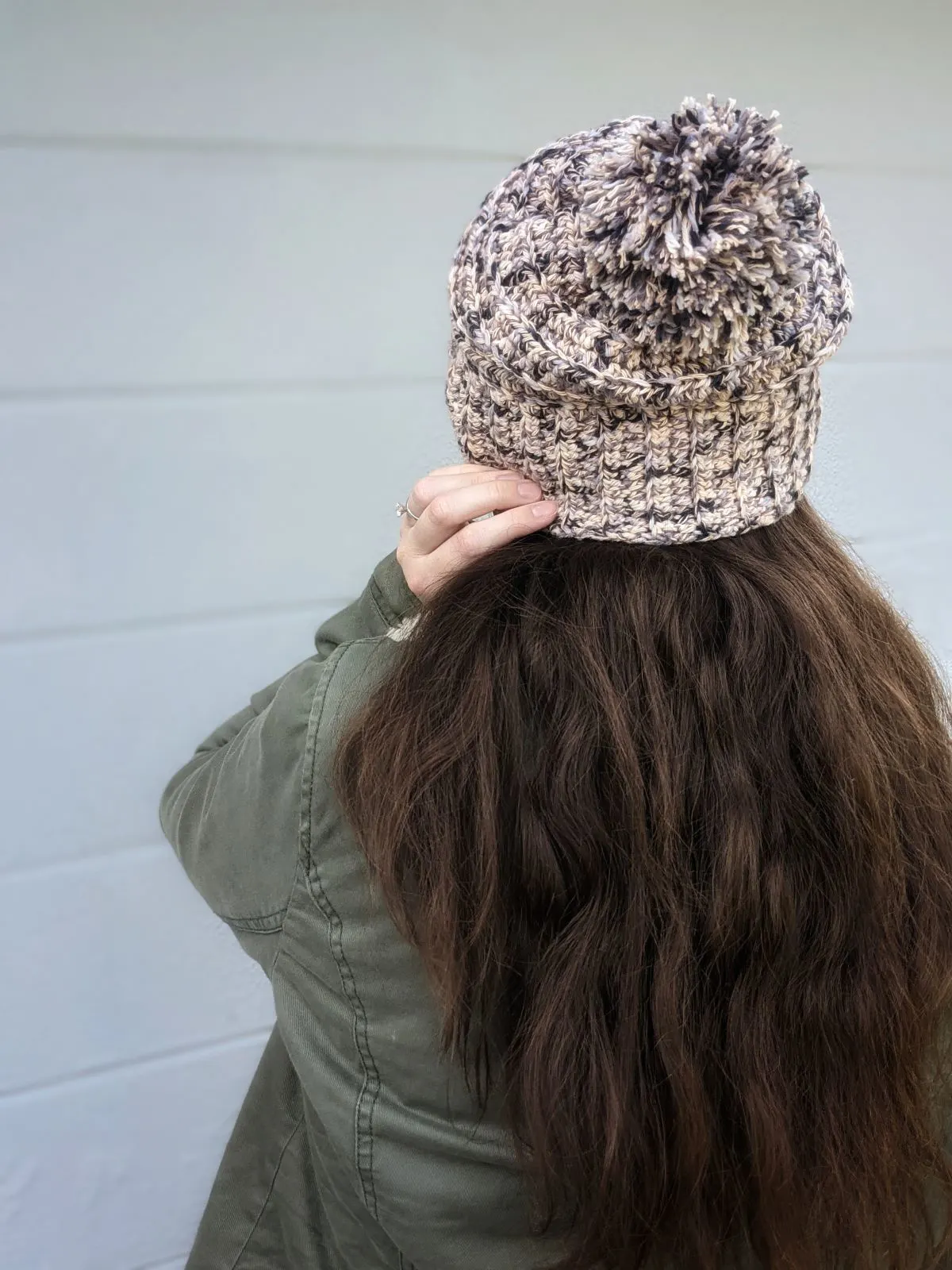 model is wearing a textured ribbed crochet beanie