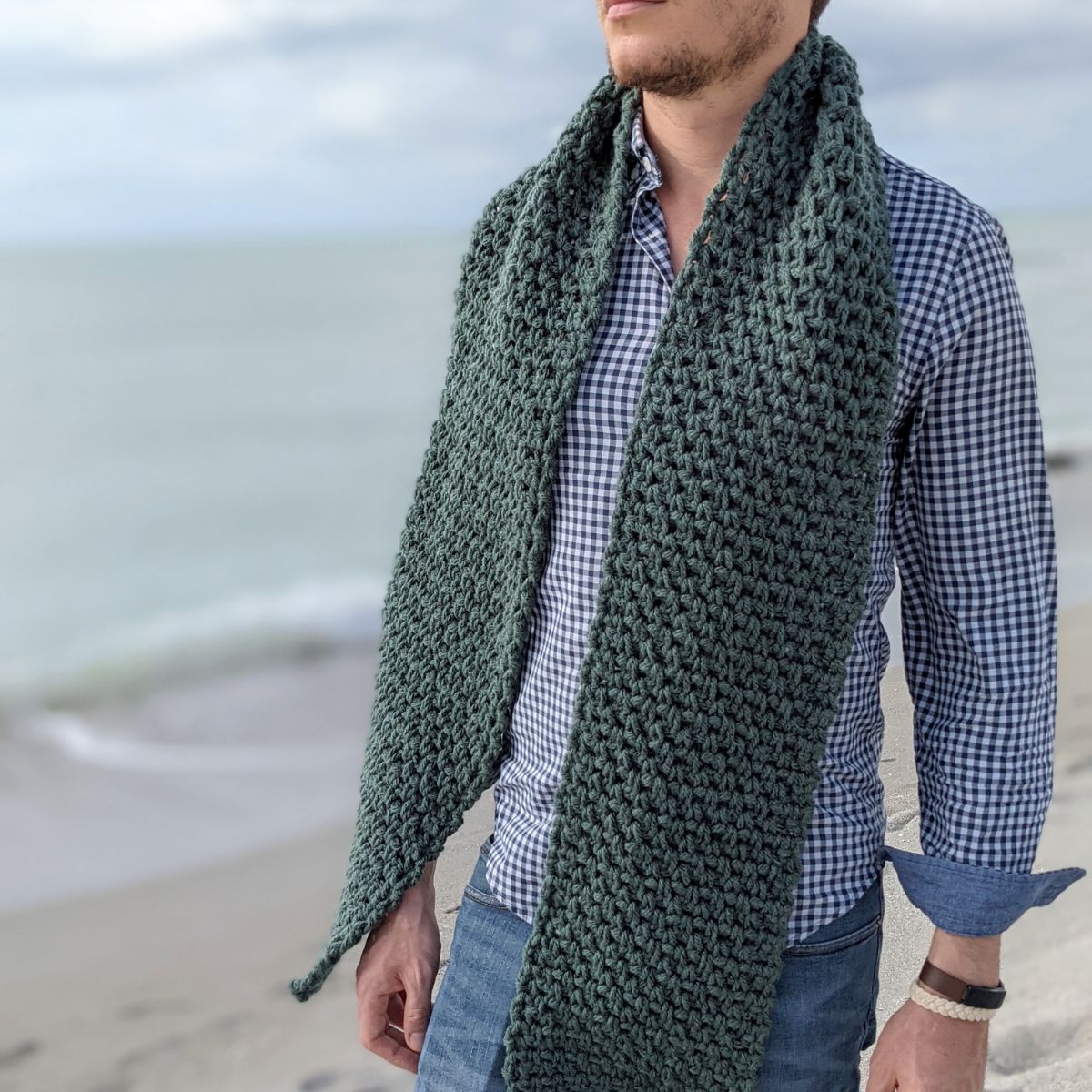 model is wearing a textured classic bulky weight men's crochet scarf, a free crochet scarf pattern.