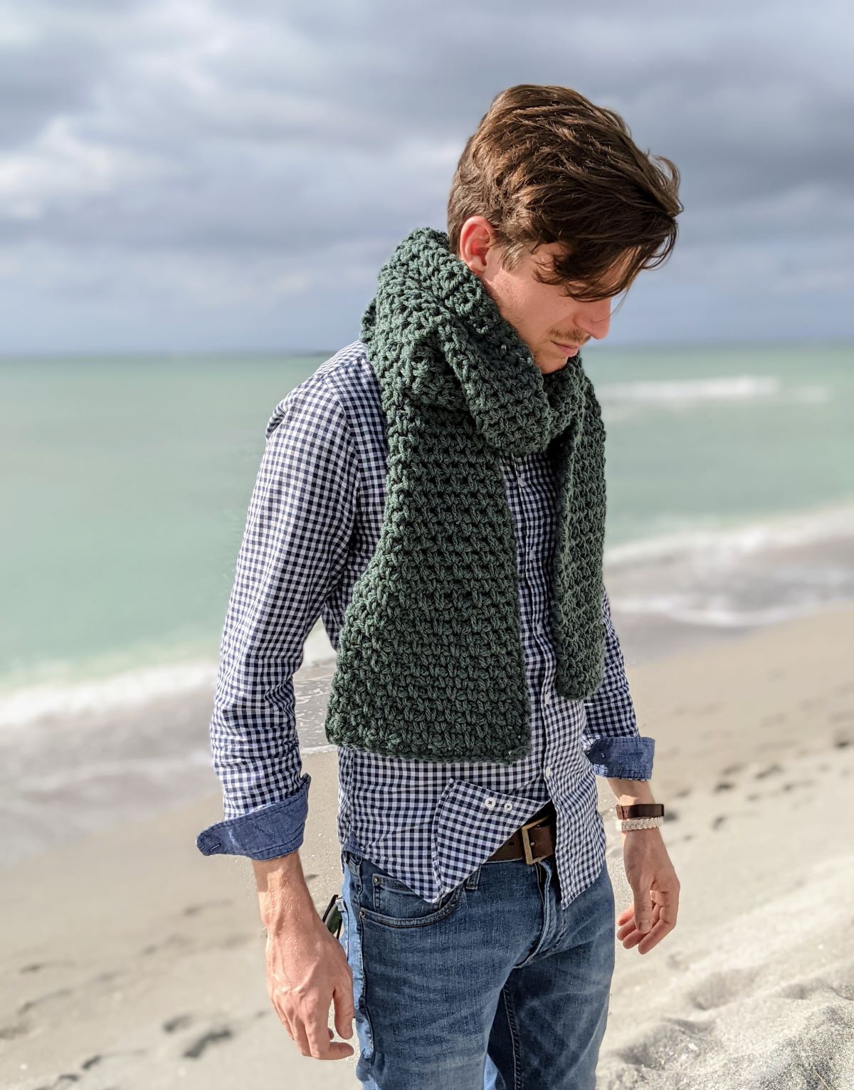 model is wearing a classic ribbed crochet scarf that is made with the granite stitch