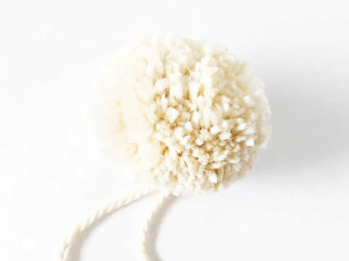 A fluffy pom pom that is made with a bulky weight yarn. 