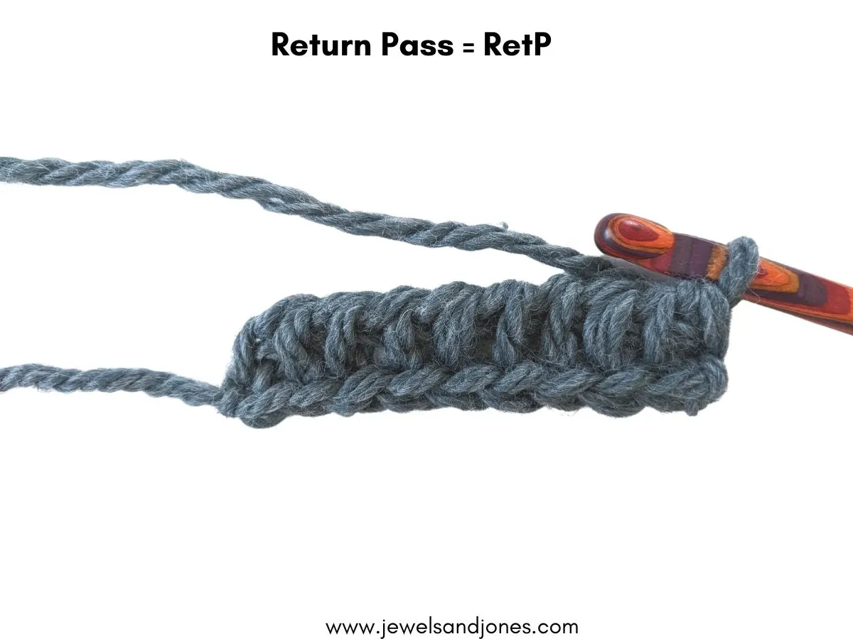 Image shows how to make a return pass in Tunisian crochet.