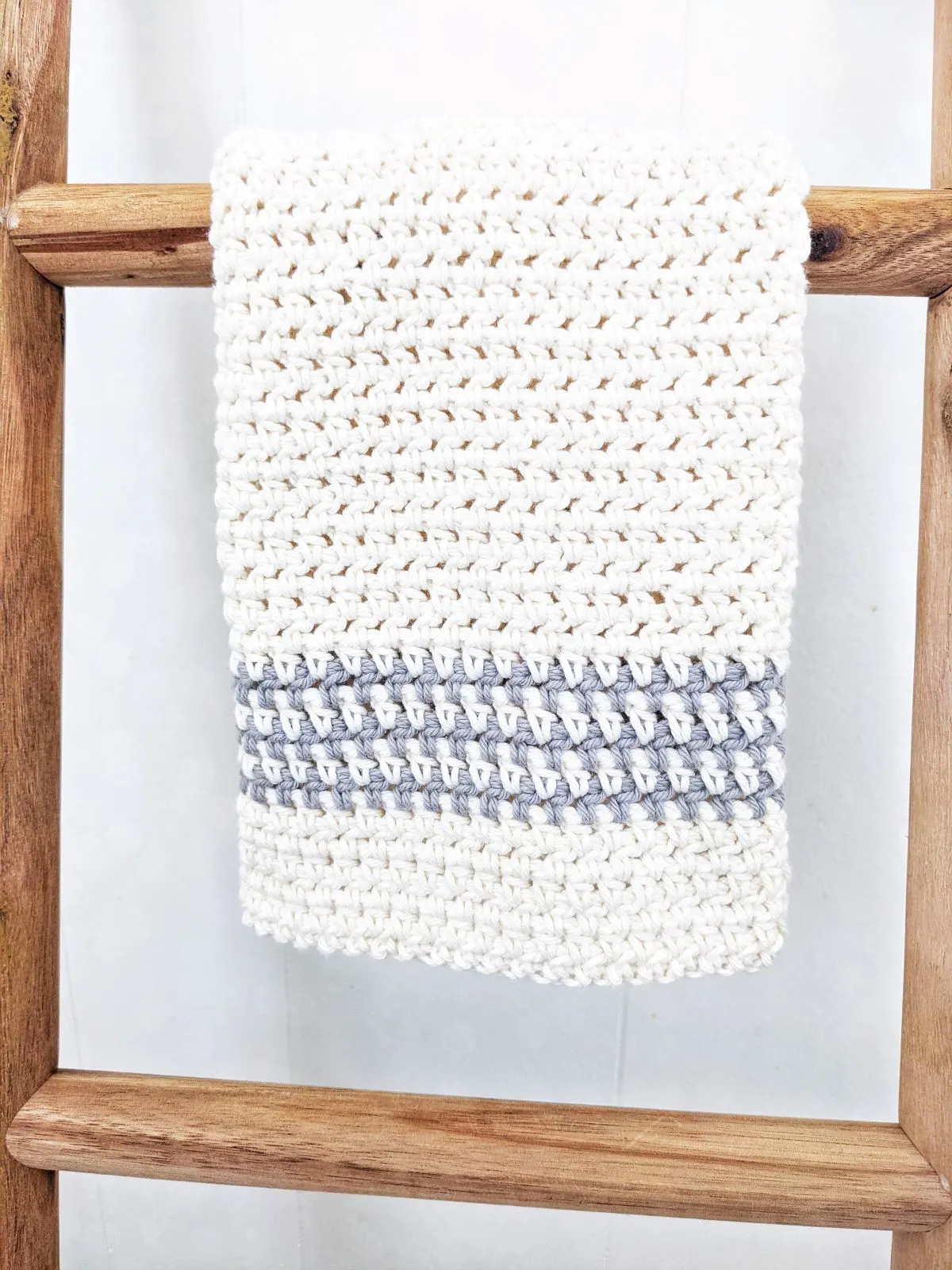 Photo shows a hand towel on a decorative ladder.