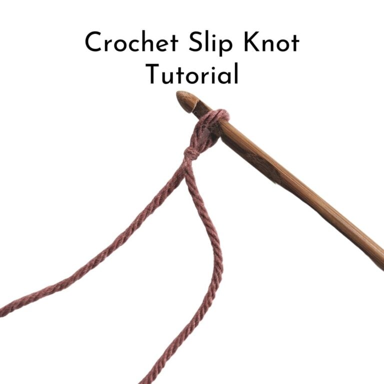 Image shows a wooden crochet hook with a slip knot on it.