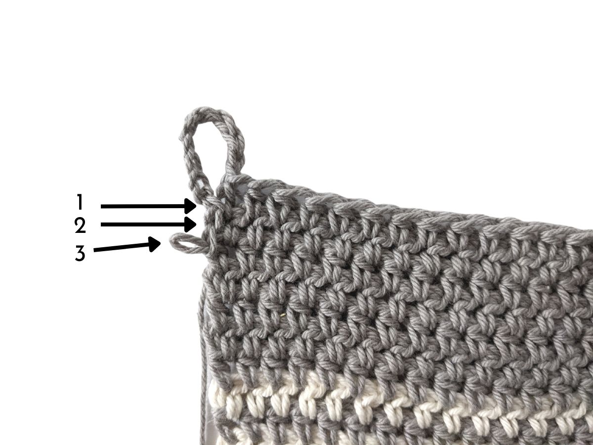 A crochet kitchen towel with a loop.