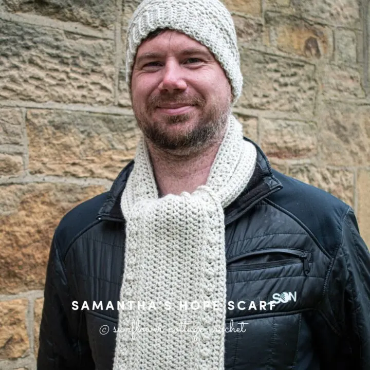 model is wearing a beanie and scarf set in the color cream.