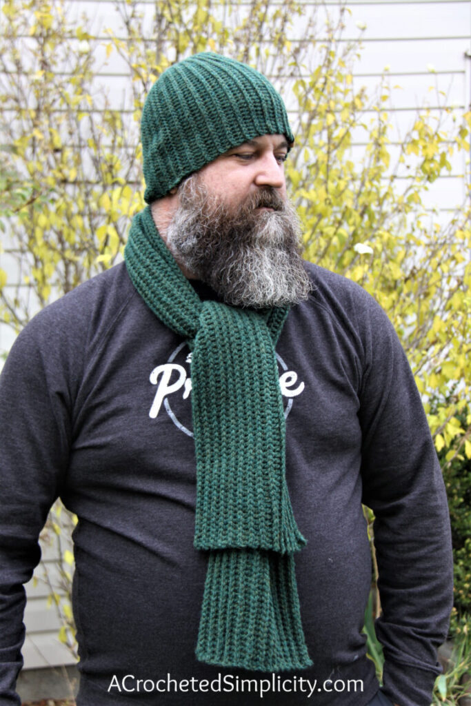 A green reversible crochet scarf.