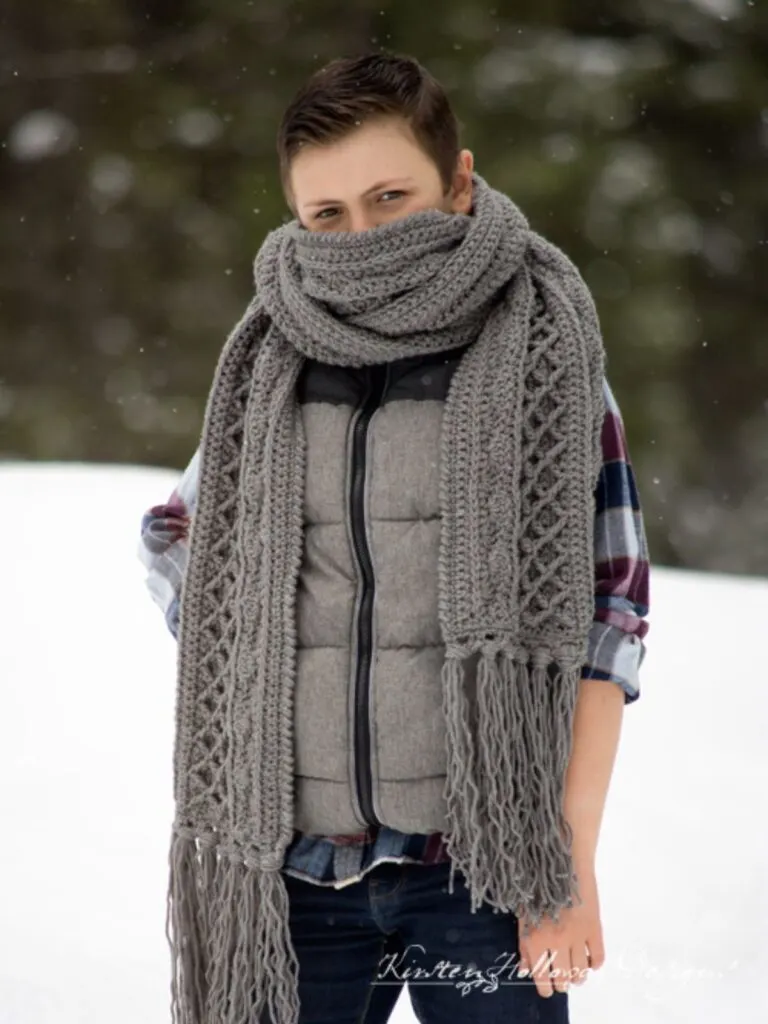 model is wearing an oversized scarf.