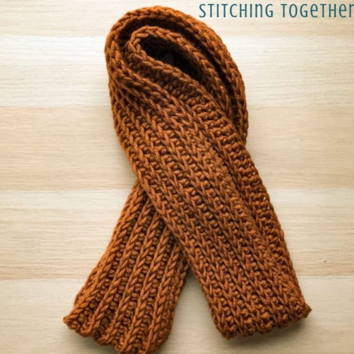 image shows a folded orange scarf.