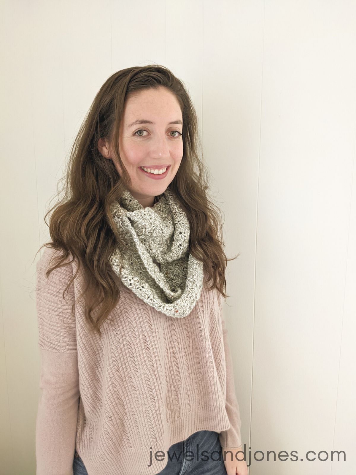 A crochet infinity scarf that's made using the shell stitch.