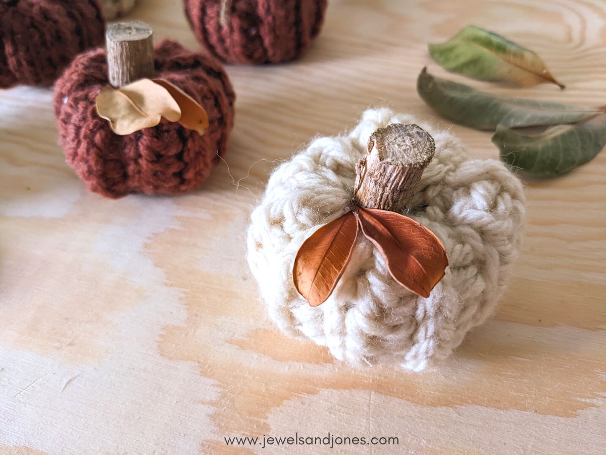 Two small crochet pumpkin patterns in white and dusty red. 