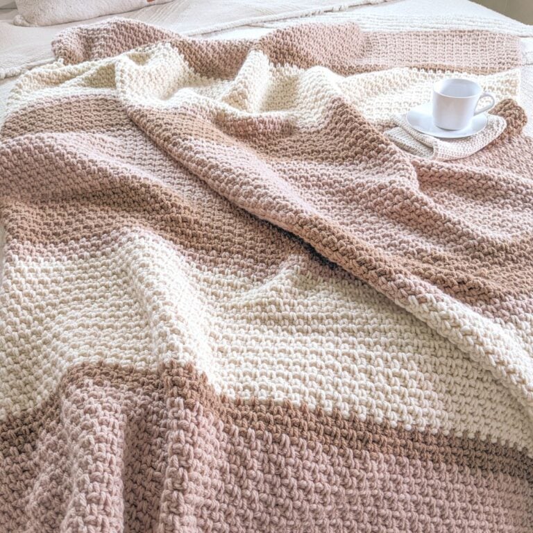 A free striped crochet blanket pattern that has 3 different colors.