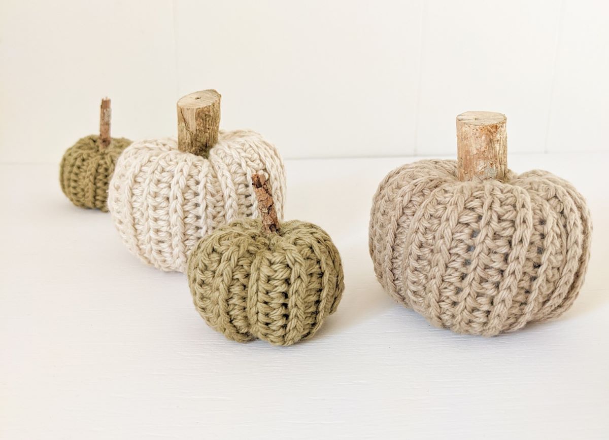 4 worsted weight crochet pumpkins in different colors.