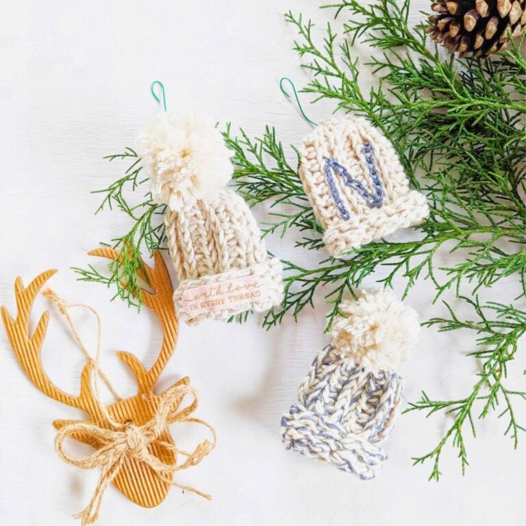 Mini crochet beanie ornament with pom poms.