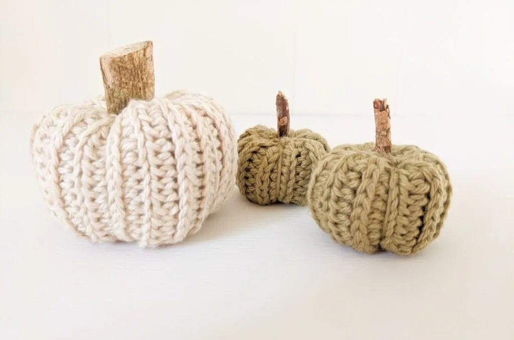 Three different size crochet pumpkins.