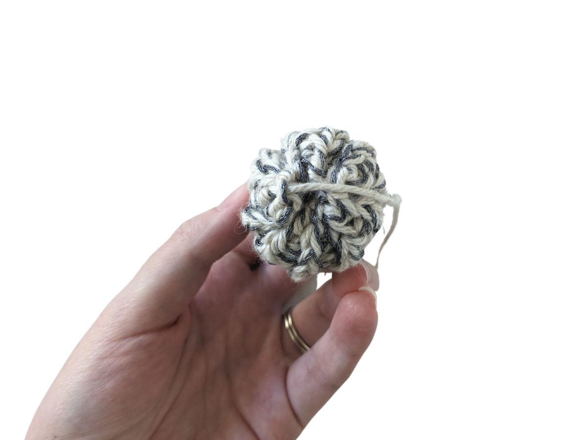 The top of a mini crochet beanie. 