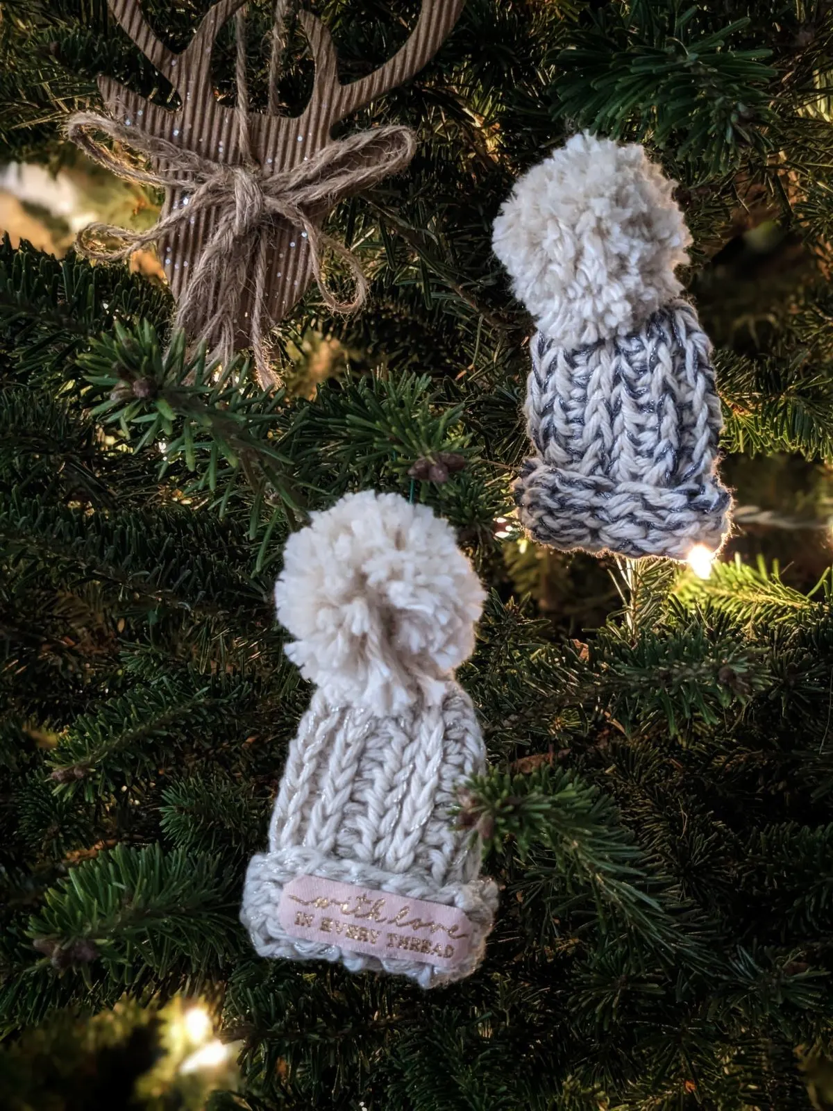 A mini crochet beanie ornament in a Christmas tree.