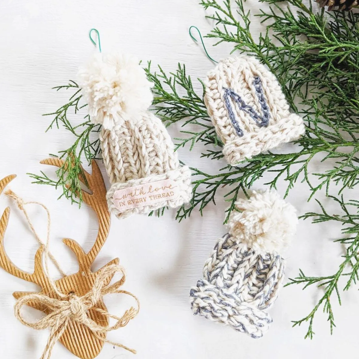 Mini crochet beanie ornament with pom poms.