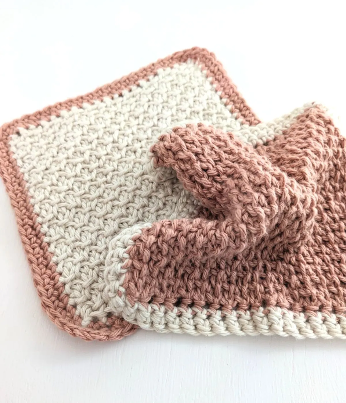 A Tunisian crochet wash cloth that is shown from the front + back side.