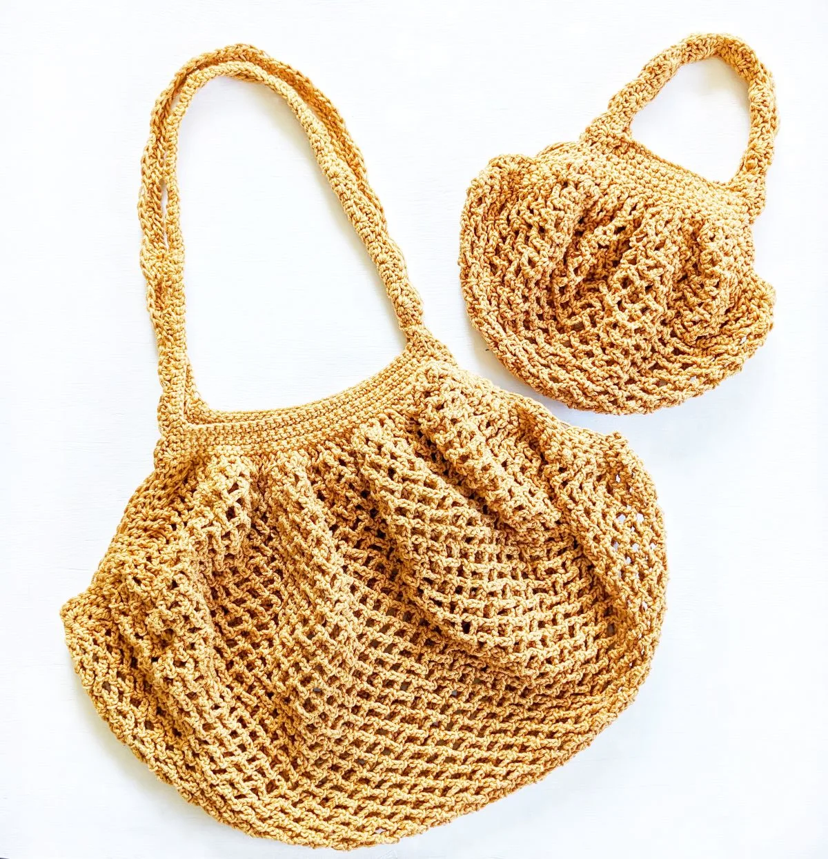 A large crochet farmers market bag and a small crochet farmers market bag. 