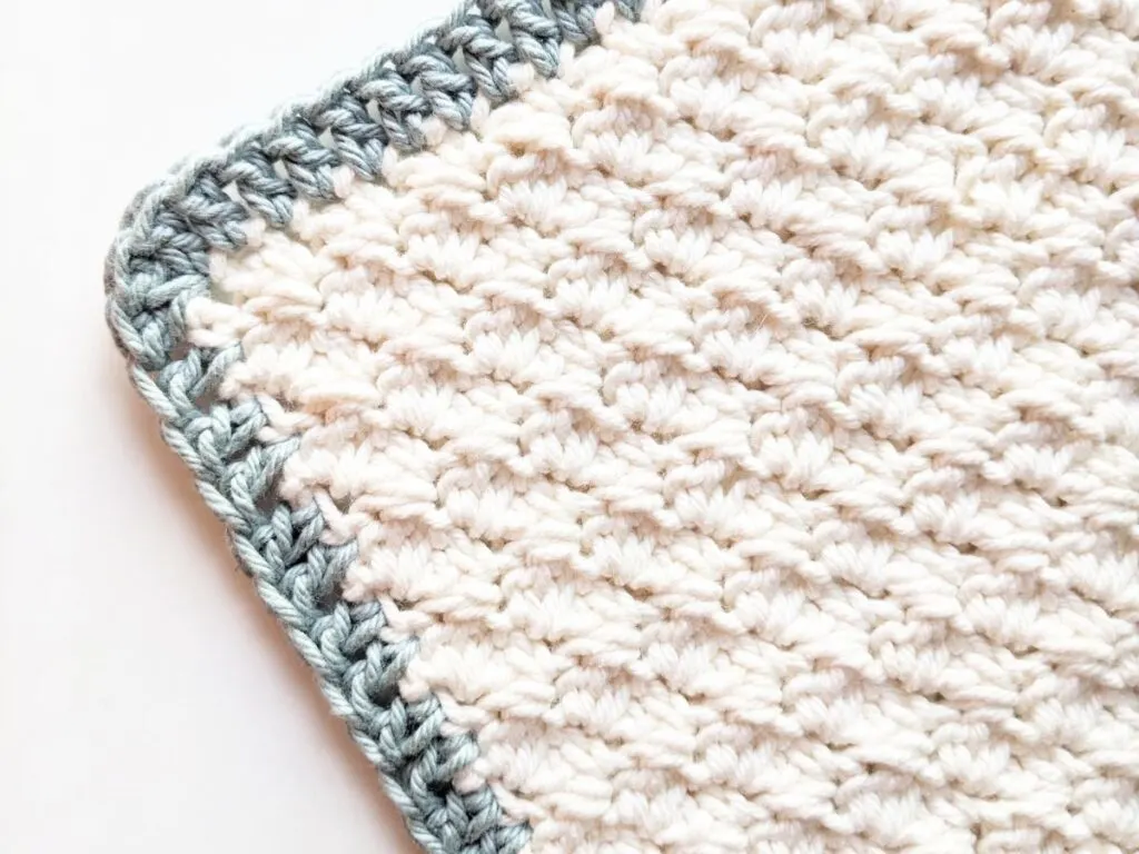Double crochet border on a crochet washcloth.