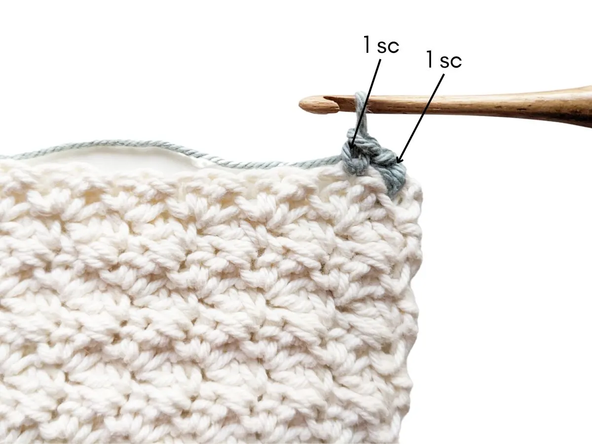 A single crochet stitch is added to a blanket to make a border.