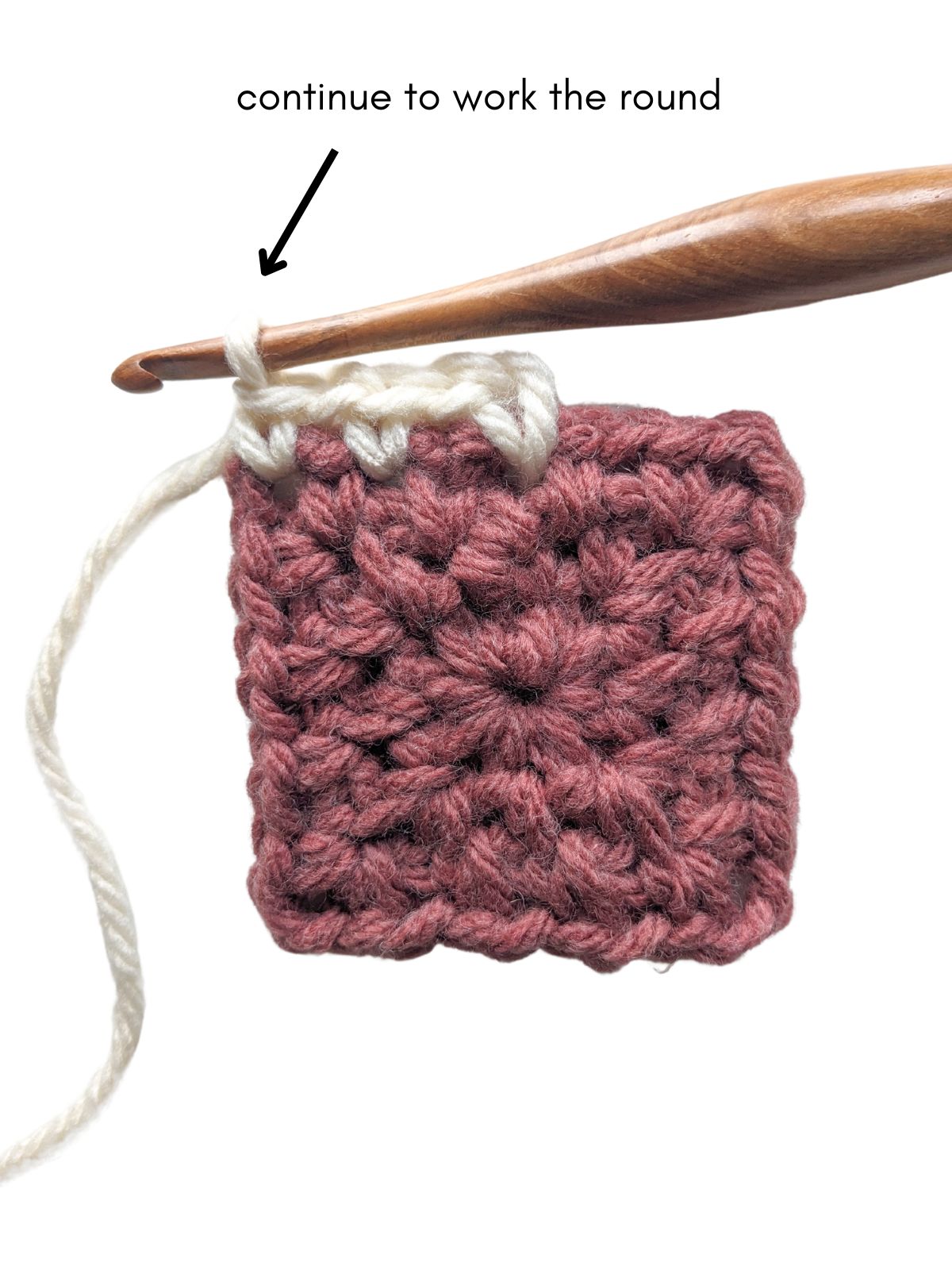 A moss stitch square with a new color of yarn being added. 