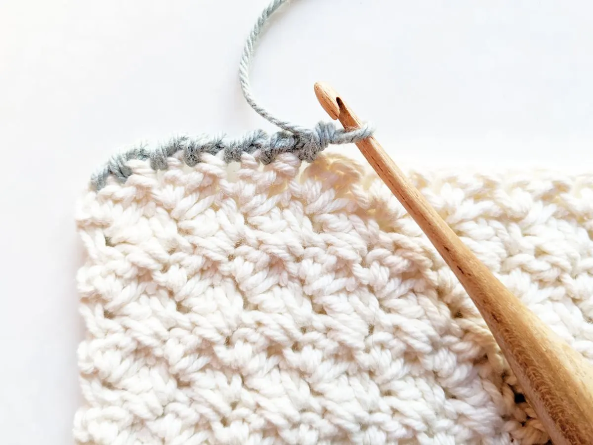 A crochet swatch with a crab stitch border. 