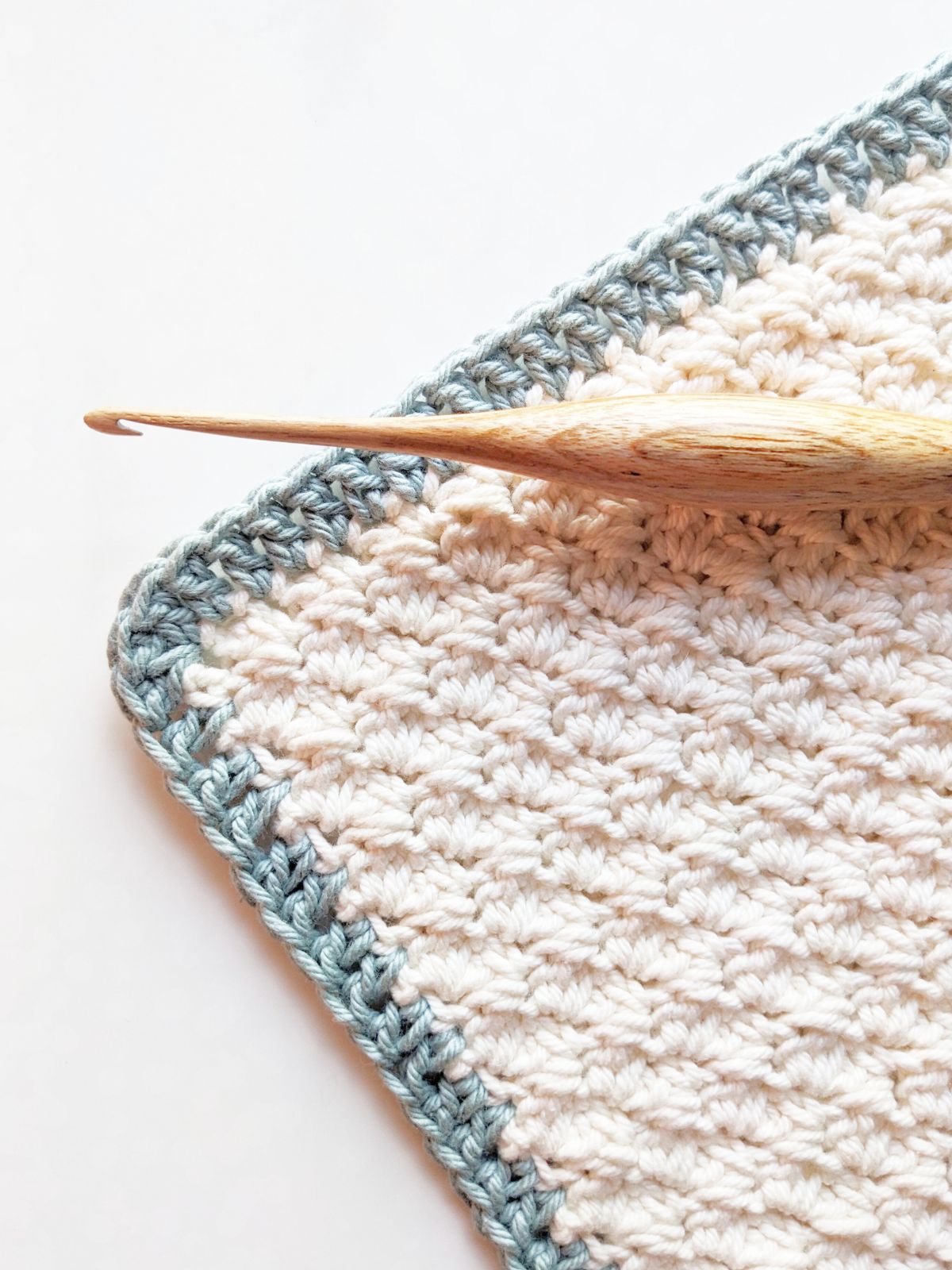 A crochet swatch with a double crochet border.