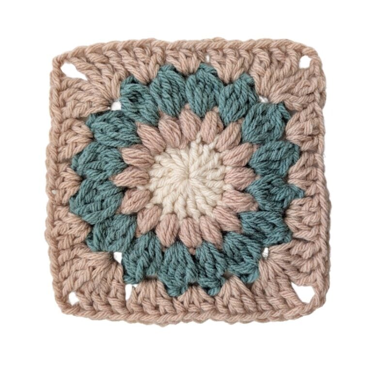 A sunburst granny square with three different colors.