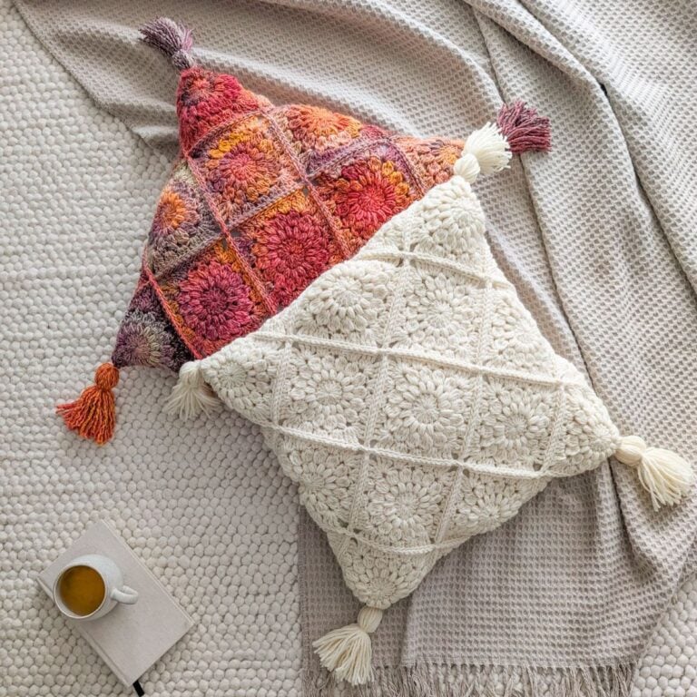 A crochet pillow made with sunburst granny squares.
