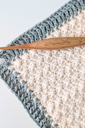 A treble crochet border with a crochet hook.