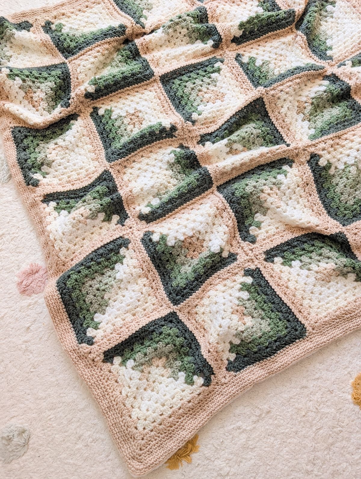 A crochet baby blanket made with granny squares.