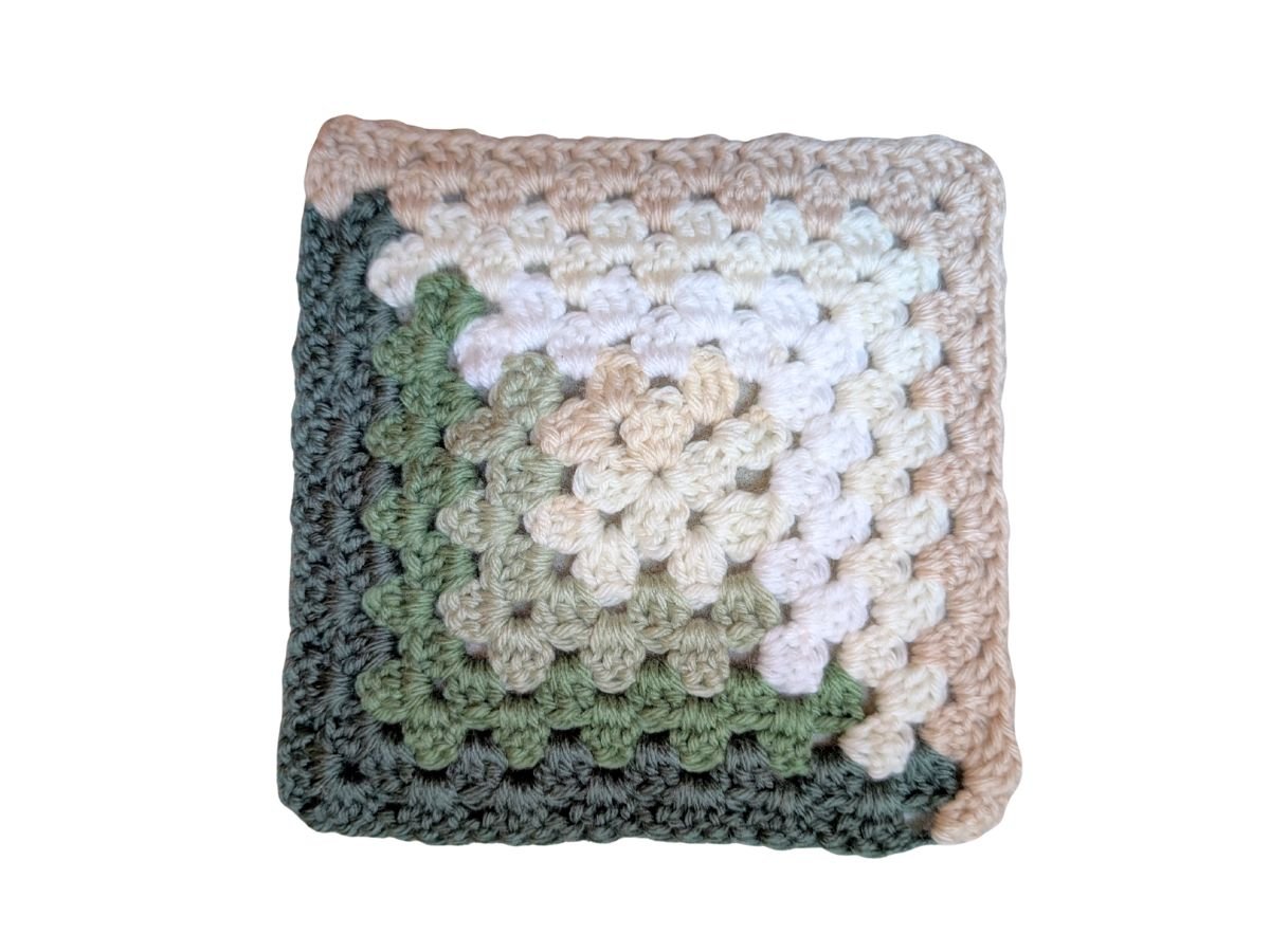 A crochet granny square that uses 7different colored yarns.