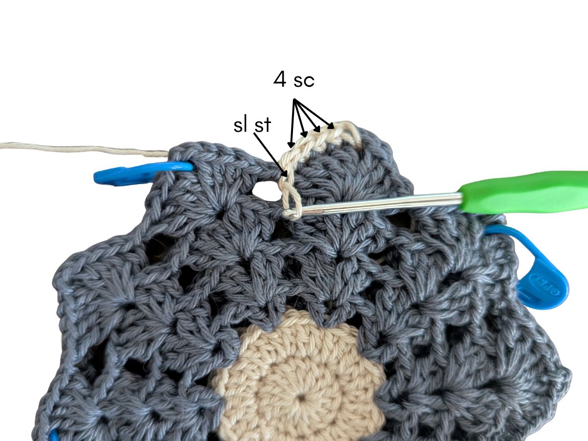 New stitches are being added to the petal part of the coaster.