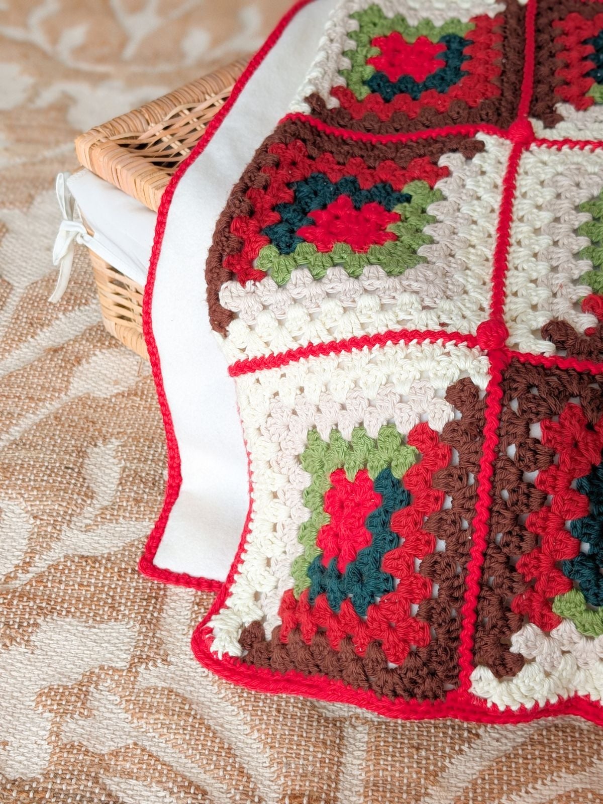 A crochet christmas inspired blanket with a fleece lining on the back.